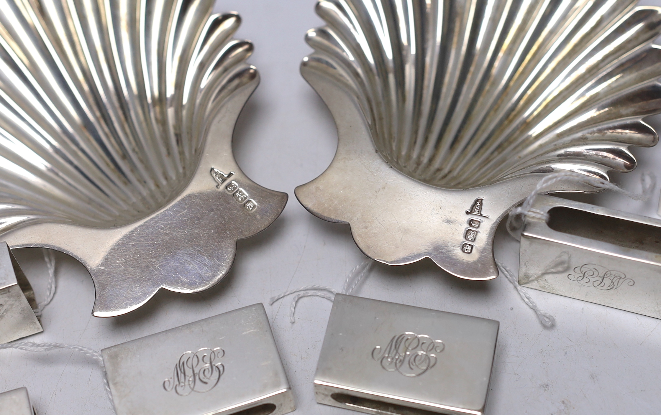 A pair of late Victorian silver butter shells, Walker & Hall, Sheffield, 1898, 12.6cm, together with a set of eight George VI silver matchbox sleeves, Birmingham, 1937.